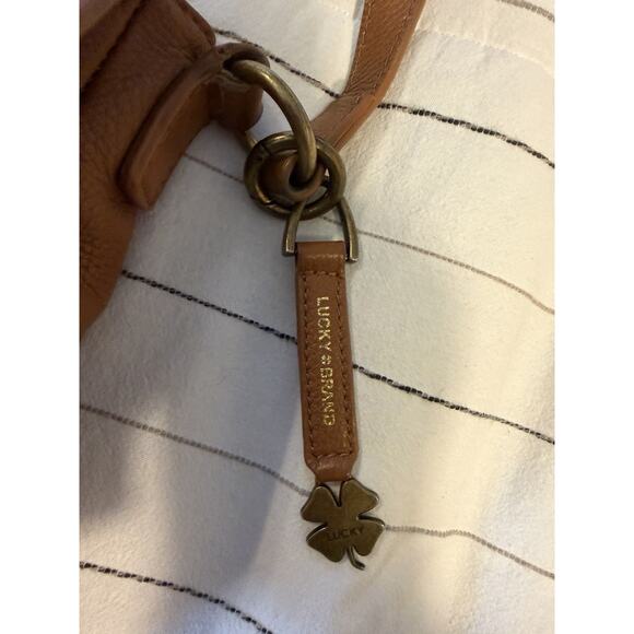 Lucky Brand | Ali Cognac Pebble Leather Flap Crossbody Saddle Bag Tan Tassel - Picture 5 of 12